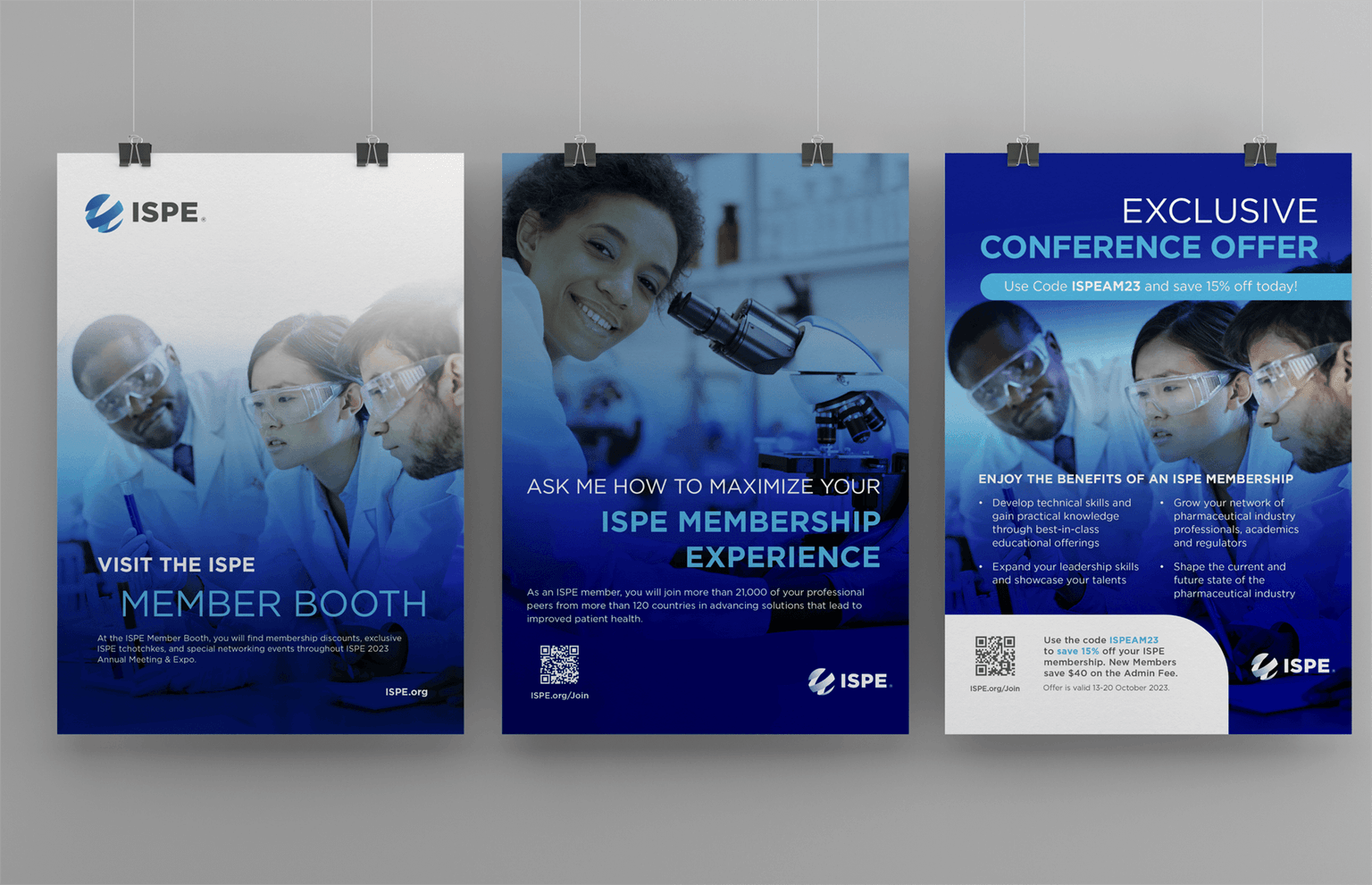 Three hanging posters promoting ISPE membership. Each features scientists in lab settings with messages about visiting the ISPE member booth, maximizing membership experience, and an exclusive conference offer for 15% off membership.